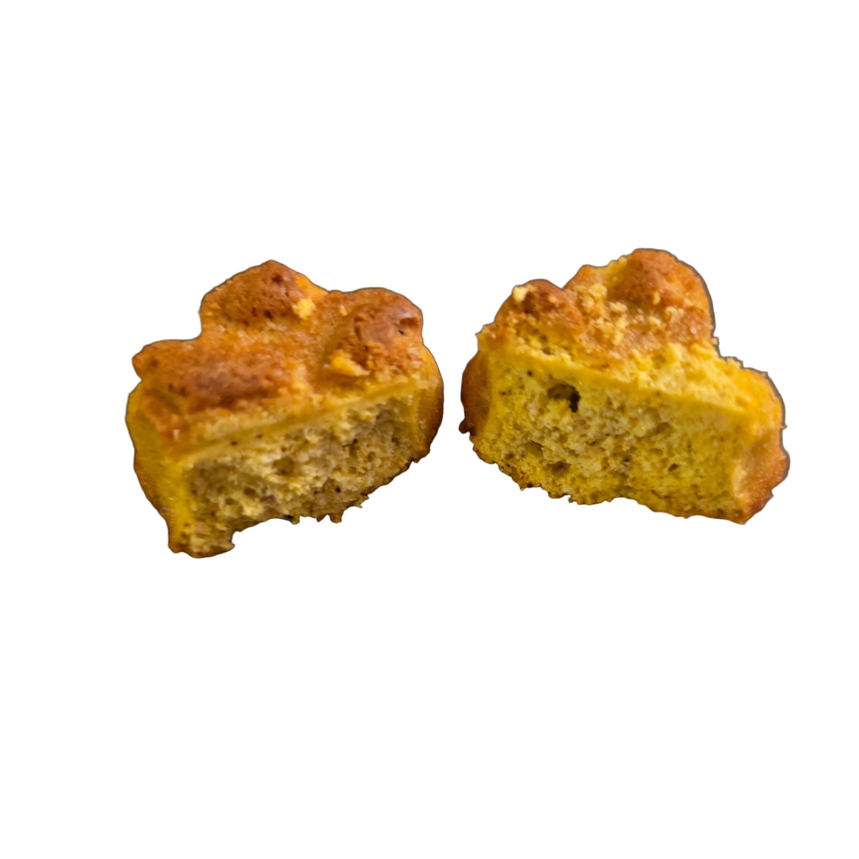Two pieces of yellow bread on a dark surface